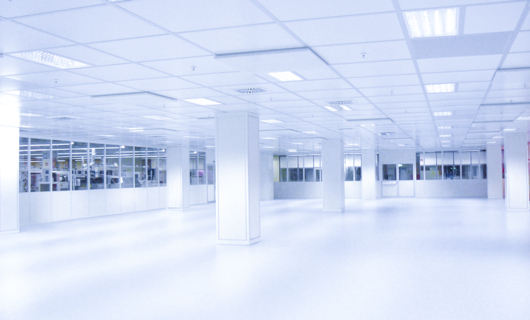 Empty, bright, white room with several columns.