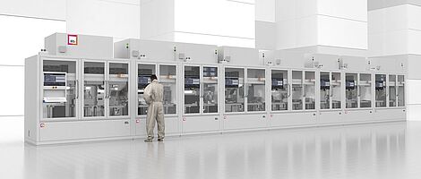 Front view of Life Sciene Final Assembly line. A man stands at a machine